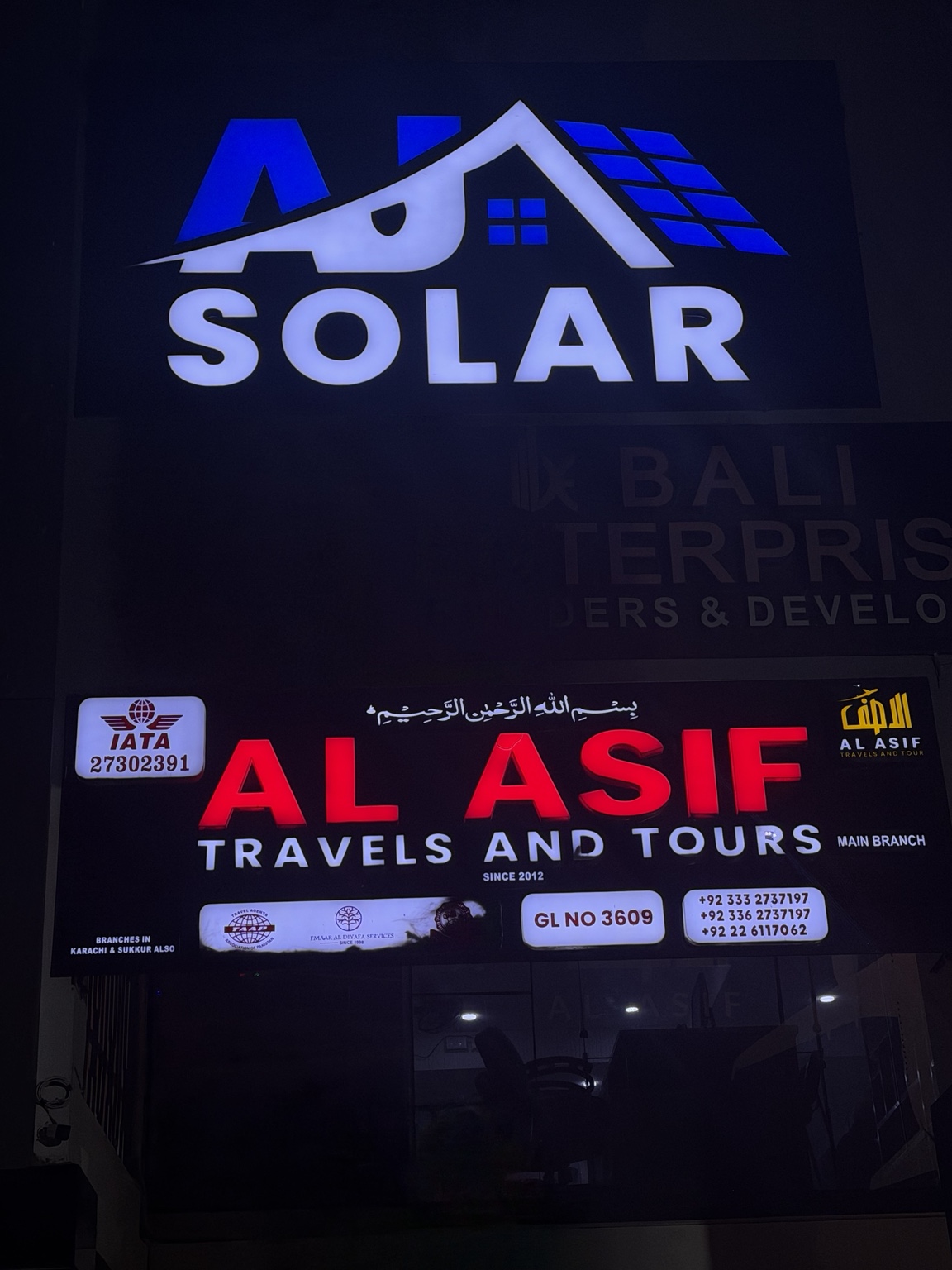 AJ Solar office sign on the first floor above the street